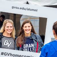 Alumnae pose with the #GVhomecoming sign